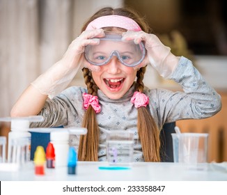 happy little girl with flasks for chemistry - Powered by Shutterstock