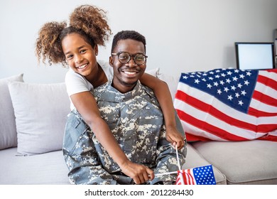 Happy little girl having fun with her military father at home. Beautiful little daughter and military father at home. Pretty little girl hugging her military father - Powered by Shutterstock