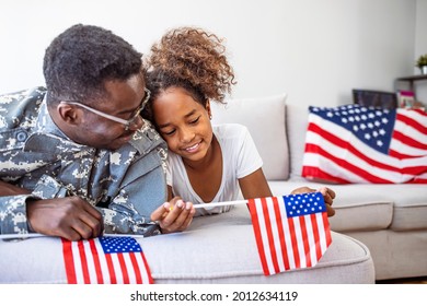 Happy little girl having fun with her military father at home. Beautiful little daughter and military father at home. Pretty little girl hugging her military father - Powered by Shutterstock