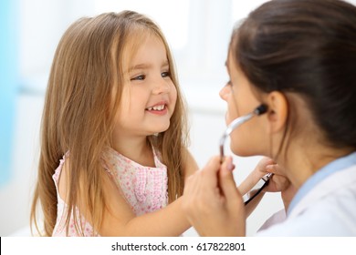 Happy little girl at  health exam at doctor office. Medicine and health care concept - Shutterstock ID 617822801