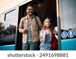 Happy little girl and her father getting out of the vehicle at bus station. 