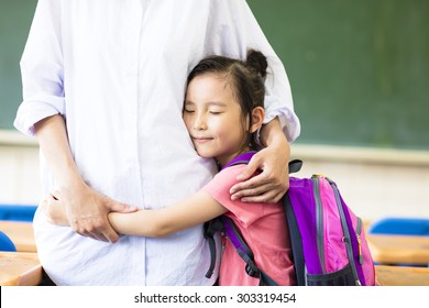 happy little Girl hugging her mother in classroom