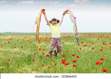 happy little girl jumping in the meadow - Shutterstock ID 192846455