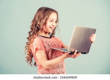 Happy Little Girl With Laptop. Shopping Online. School Project. Start Up Business. Child Development In Digital Age. Play Computer Games. Home Schooling Education. Art Director. Presenting Product.
