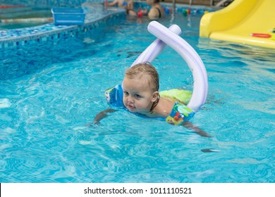 Happy Little Girl Learning To Swim With Pool Noodle