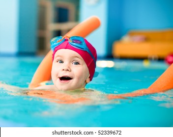 Happy little girl learning to swim with pool noodle - Powered by Shutterstock