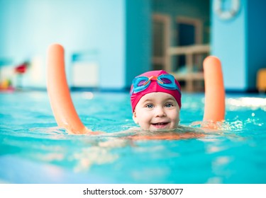 Happy little girl learning to swim with pool noodle - Powered by Shutterstock