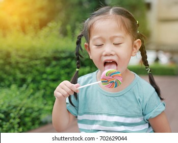 Close Little Girl Licking Lollipop Candy Stock Photo (Edit Now) 719155177