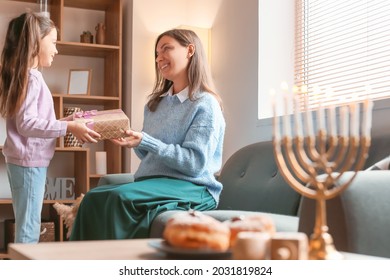 Happy Little Girl With Mother Celebrating Hannukah At Home