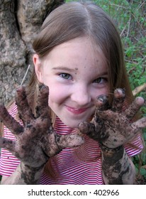 Happy Little Girl With Muddy Hands.