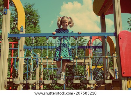 happy little girl on the playground - vintage retro style