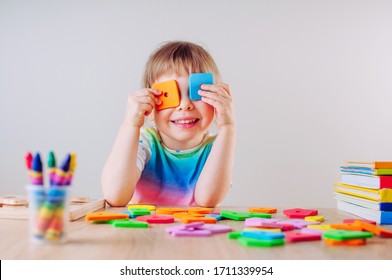 Happy Little Girl Playing With Colorful Square Shapes Using It Like Eye Glasses. Learning Educational Activities For Children At Home Or In Kindergarten.