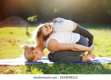 Happy Little Girl Playing With Her Mom Practicing Child Yoga Pose