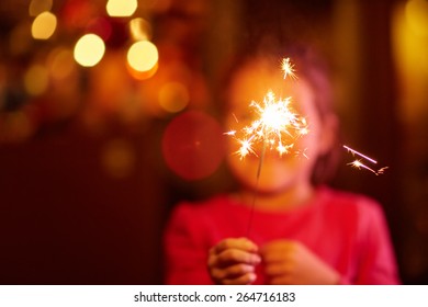 A Happy Little Girl Playing With A Sparkler