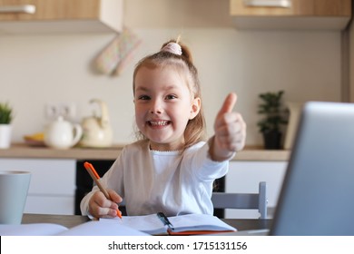 Happy Little Girl Pupil Study Online Using Laptop At Home, Smiling Small Child Show Thumb Up Recommend Class Or Lesson.