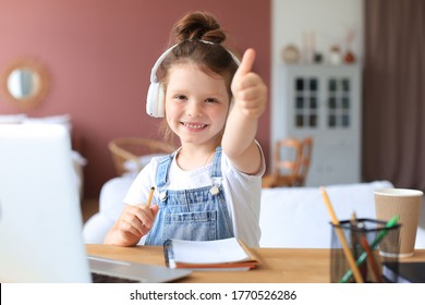 Happy Little Girl Pupil Study Online Using Laptop At Home, Smiling Small Child Show Thumb Up Recommend Class Or Lesson.