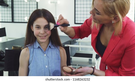 Happy Little Girl Smiling While Her Mom Applying Makeup On Her Face