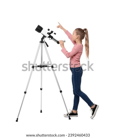Happy little girl with telescope pointing at something on white background