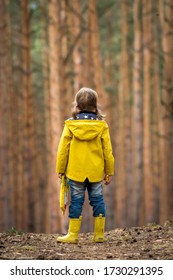 Happy Little Girl In Yellow Raincoat Outdoors. Back View