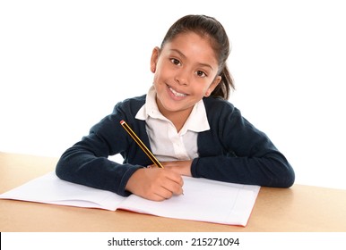 Happy little hispanic female child writing homework with pencil smiling in children education and back to school concept isolated on white background