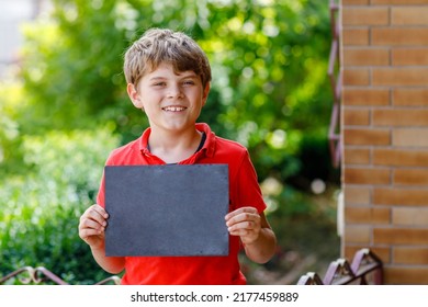 Happy Little Kid Boy With Backpack Or Satchel And Glasses. Schoolkid On The Way To School. Healthy Adorable Child Outdoors On Desk Last Day Third Grade In German. School's Out