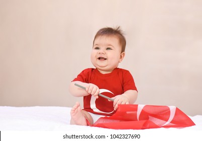 Happy, Little Kid, Cute Baby With Turkish Flag T-shirt And Holding Turkish Flag On White Background. Patriotic Holiday.