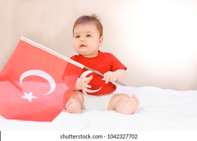 Happy, Little Kid, Cute Baby With Turkish Flag T-shirt And Holding Turkish Flag On White Background. Patriotic Holiday.