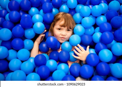 Happy Little Kid Playing At Colorful Plastic Balls Playground High View. Adorable Girl Having Fun Indoors, Kindergarten