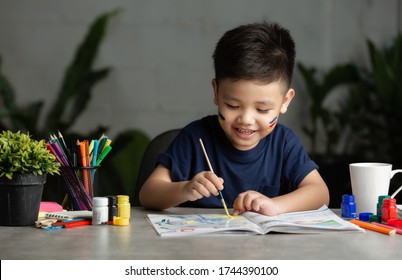 Happy little kid at the table draw with water color Learning and education of kid. - Powered by Shutterstock