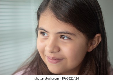 Happy little latin girl looking with hope. Portrait