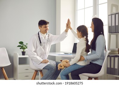 Happy little patient high-fiving doctor. Young mother and daughter seeing trustworthy pediatrician or family practitioner. Concept of children's visit to hospital and positive attitude to healthcare