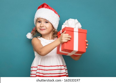 Happy little smiling girl  with  christmas gift  box.