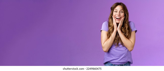 Happy lively lucky enthusiastic girl curly hairstyle open mouth admiration fascinated smiling broadly touch cheek impressed surprised awesome incredible positive news stand purple background. - Shutterstock ID 2249860475