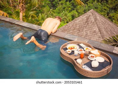 Happy Loner Hanging On Swimming Pool Edge At Hotel