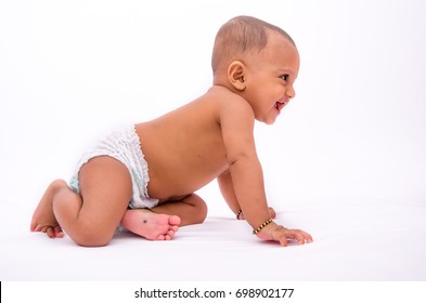 Happy Looking Nine Months Old Infant Indian Baby In A Diaper, Isolated On A White Background.