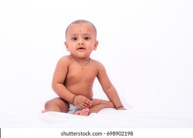 Happy Looking Nine Months Old Infant Indian Baby In A Diaper, Isolated On A White Background.