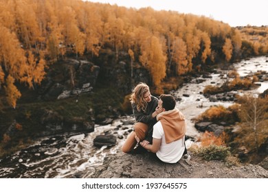 Happy in love romantic young cheerful couple man and woman married travel hiking walk together among the autumn forest and mountains looking for adventure enjoy the local nature, selective focus - Powered by Shutterstock