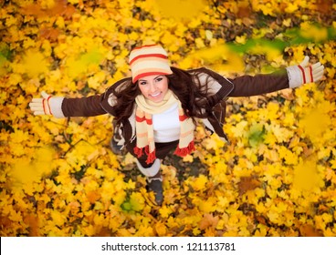 happy lovely and beautiful woman in forest in fall colors, celebrating coming autumn