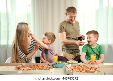 Happy lovely family eating pizza - Powered by Shutterstock