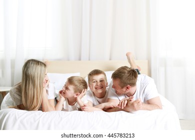 Happy lovely family on bed - Shutterstock ID 445783213