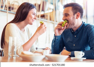 Happy loving couple enjoying breakfast in cafe. Love, food and  lifestyle concept. - Shutterstock ID 521701180