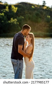 Happy Loving Couple Kissing And Having Date Outdoors. Young Couple On Summer Picnic With Watermelon.