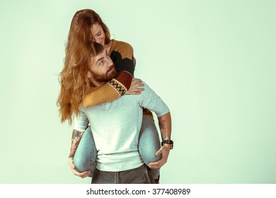 Happy Loving Couple On Grey Background. Studio Shot