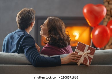 Happy loving couple on valentine's day. Man and woman are enjoying spending time at home. - Shutterstock ID 2108591966