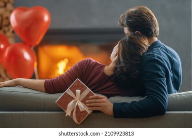 Happy loving couple on valentine's day. Man and woman are enjoying spending time at home.