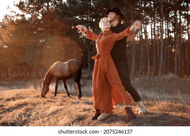 
Happy And Loving Couple In The Setting Sun On A Horse Farm