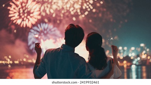 Happy loving couple watching fireworks. - Powered by Shutterstock