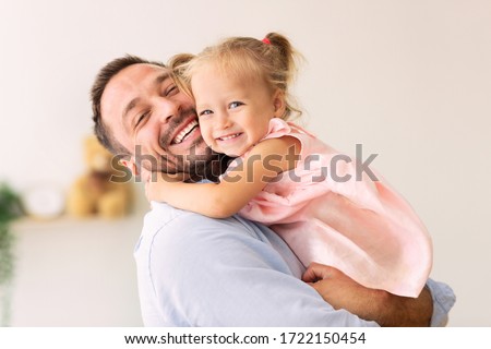 Happy Loving Family. Dad hugging his little daughter and looking at camera. Copy space, banner