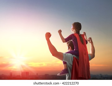 Happy loving family. Father and his daughter child girl playing outdoors. Daddy and his child girl in an Superhero's costumes. Concept of Father's day. - Shutterstock ID 422212270