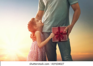 Happy Loving Family And Father's Day. Father And His Daughter. Cute Child Girl Gives A Gift To Dad.